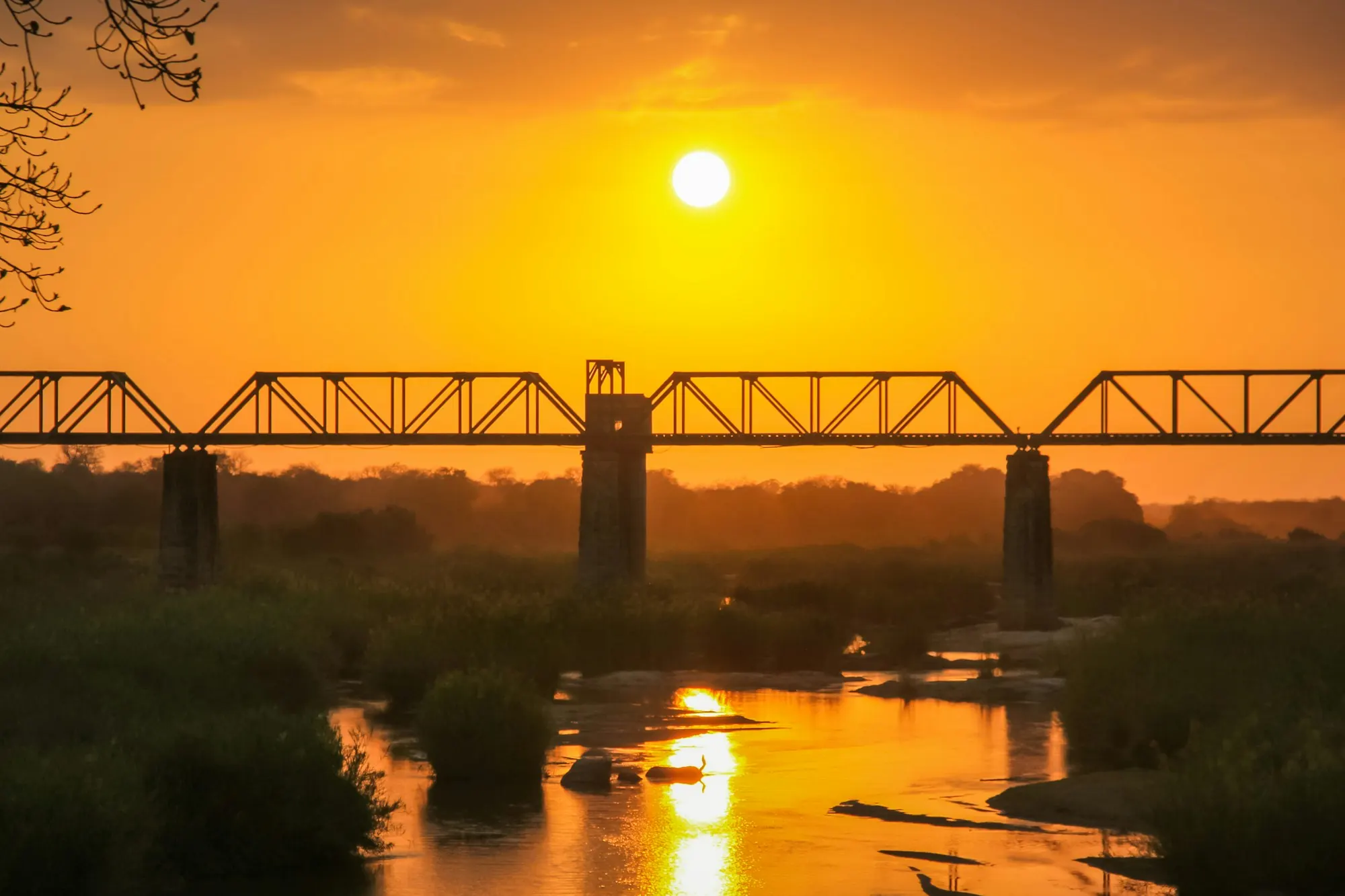 Sunset over the Sabie River and the old railway bridge in Kruger